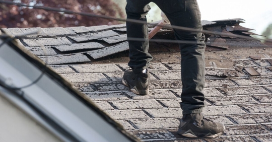 Old asphalt roof shingles being removed for replacemnt